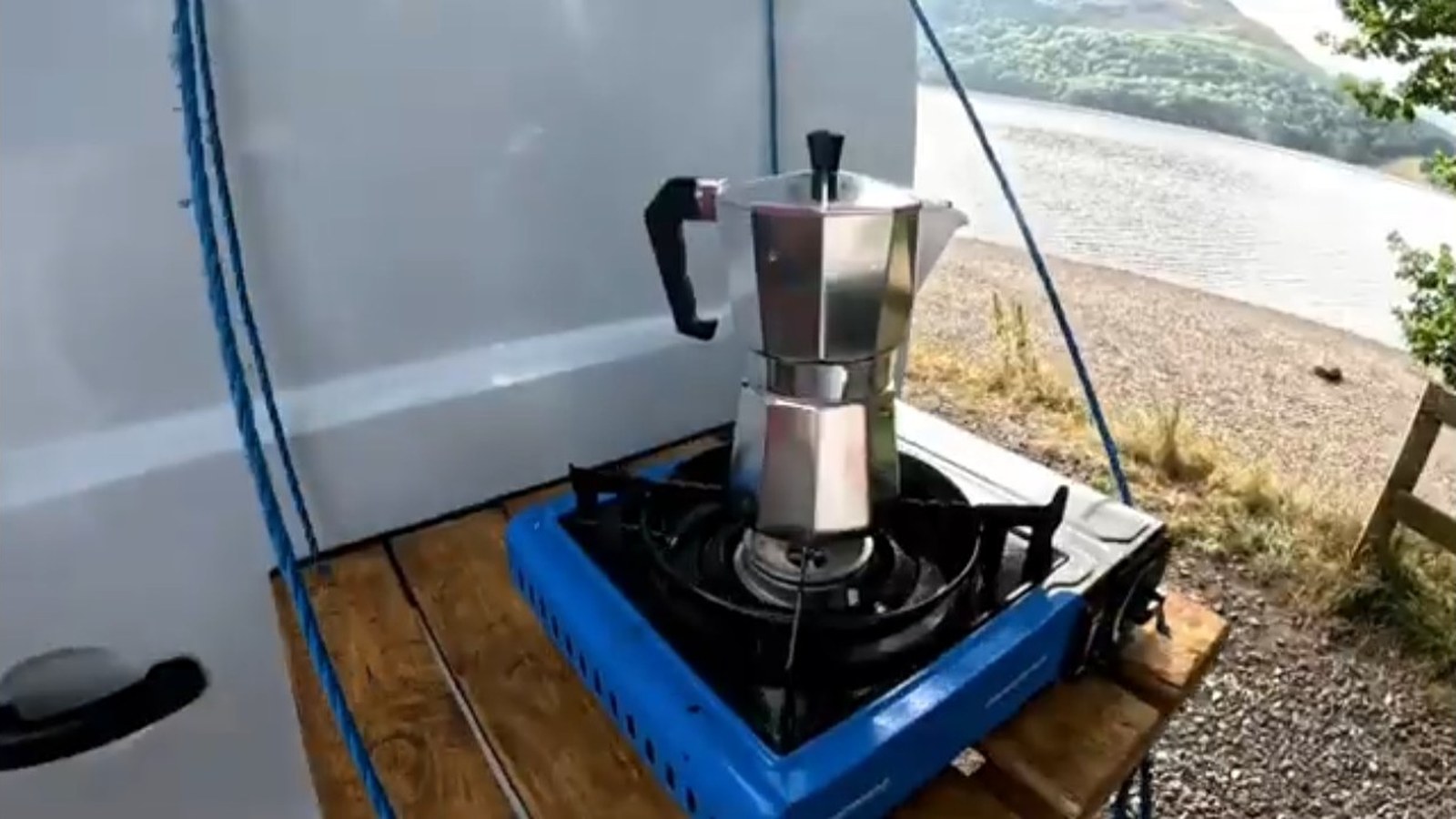Cooking outside the campervan beside a lake